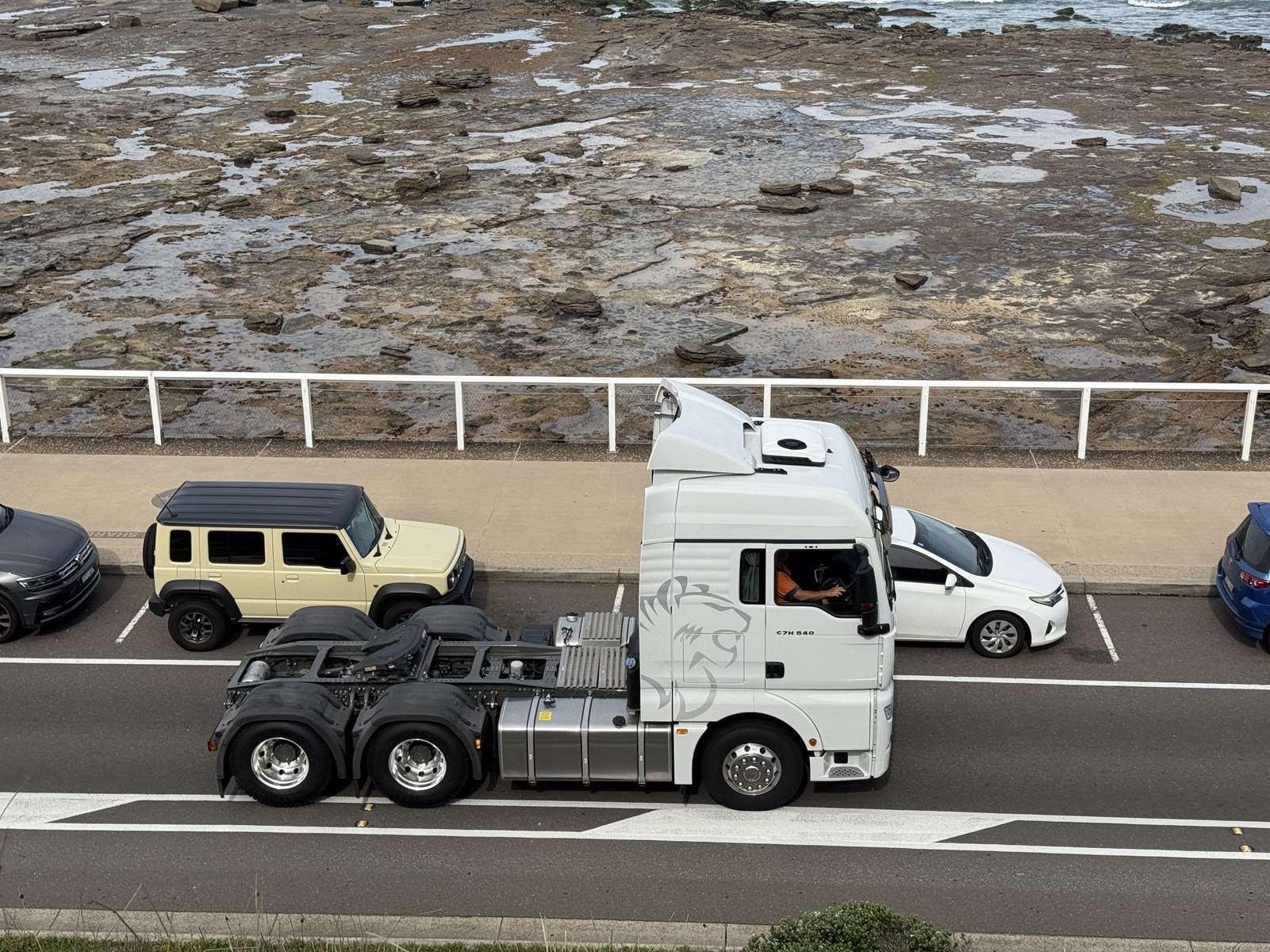 Sitrak prime mover on the road at the Newcastle foreshore